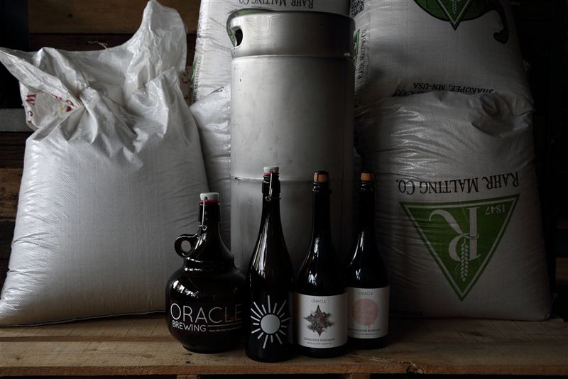Bags of malt, a keg and Oracle bottles