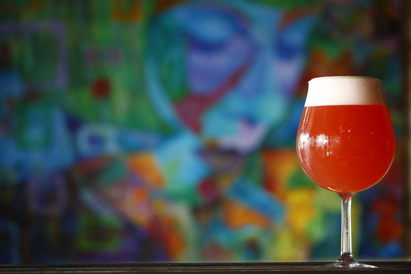 A strawberry sour in front of a painted mural